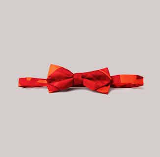 Trendlistr | Upcycled French Crepe Kid's Bow Headband | Orange Triangles On Red from Kapdaa - The Offcut Company in organic baby accessories, sustainable baby & toddler clothing